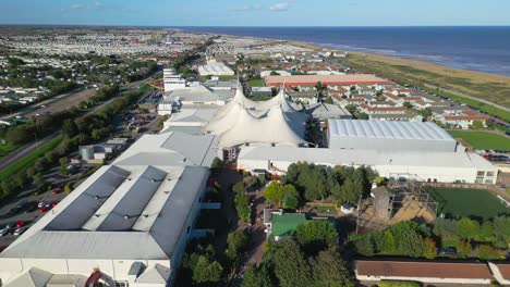 Aerial-drone-footage-of-the-famous-Butllins-holiday-camp-based-in-the-seaside-town-of-Skegness-Lancashire,-UK