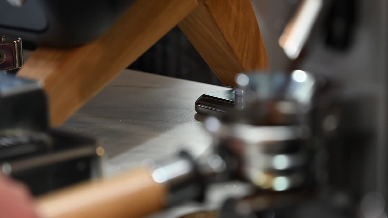Close up of a barista making a coffee at a cafe with a professional machine