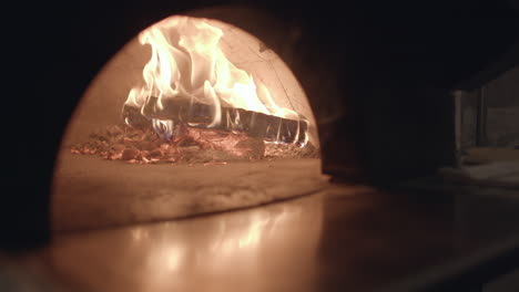 slow motion closeup of wood burning in a neapolitan style pizza oven