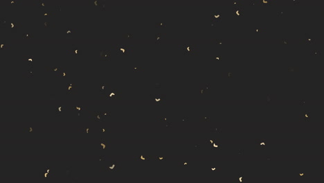 flying gold confetti on black gradient