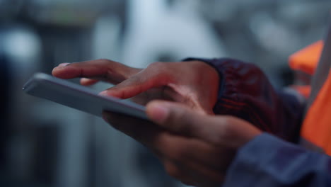 engineer hands use tablet computer at modern manufacturing factory close up