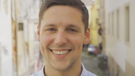 happy young man with piercing looking at camera.