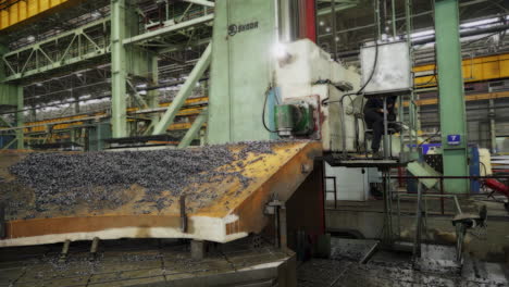 large industrial machine processing metal plate in a factory