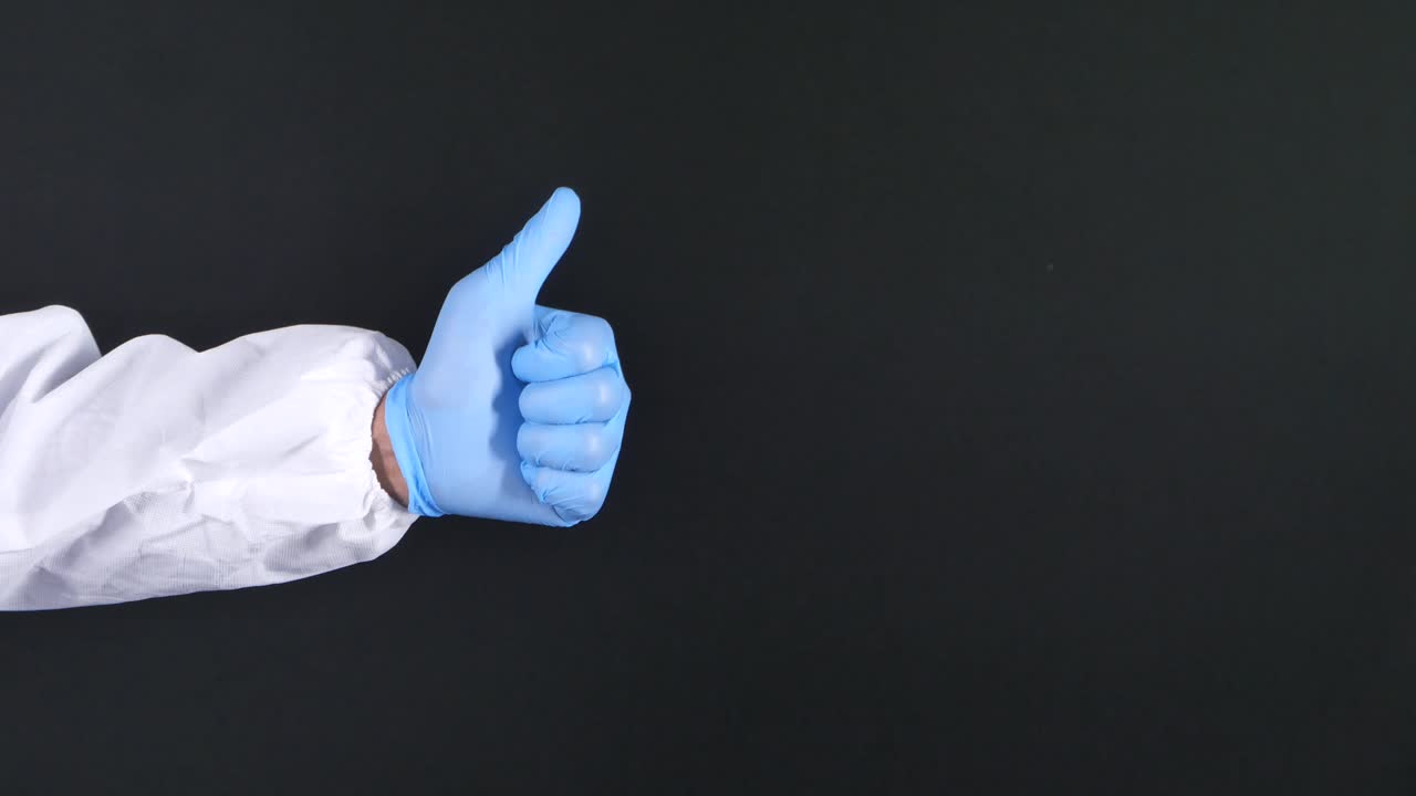 trabajador médico dando pulgares en equipo de protección