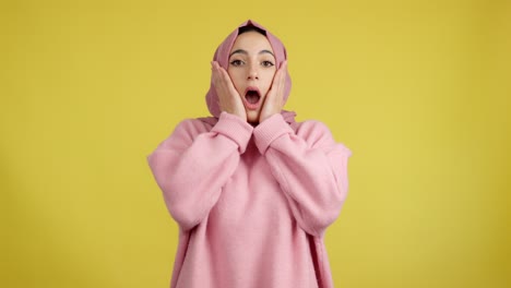 shocked woman in pink hijab
