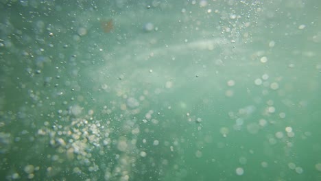 underwater bubbles with diver in background