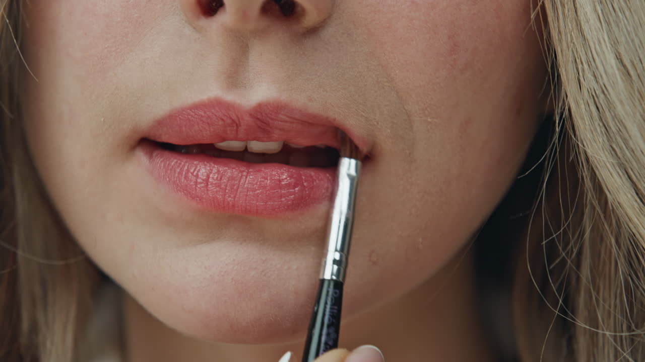 Applying lipstick with a brush