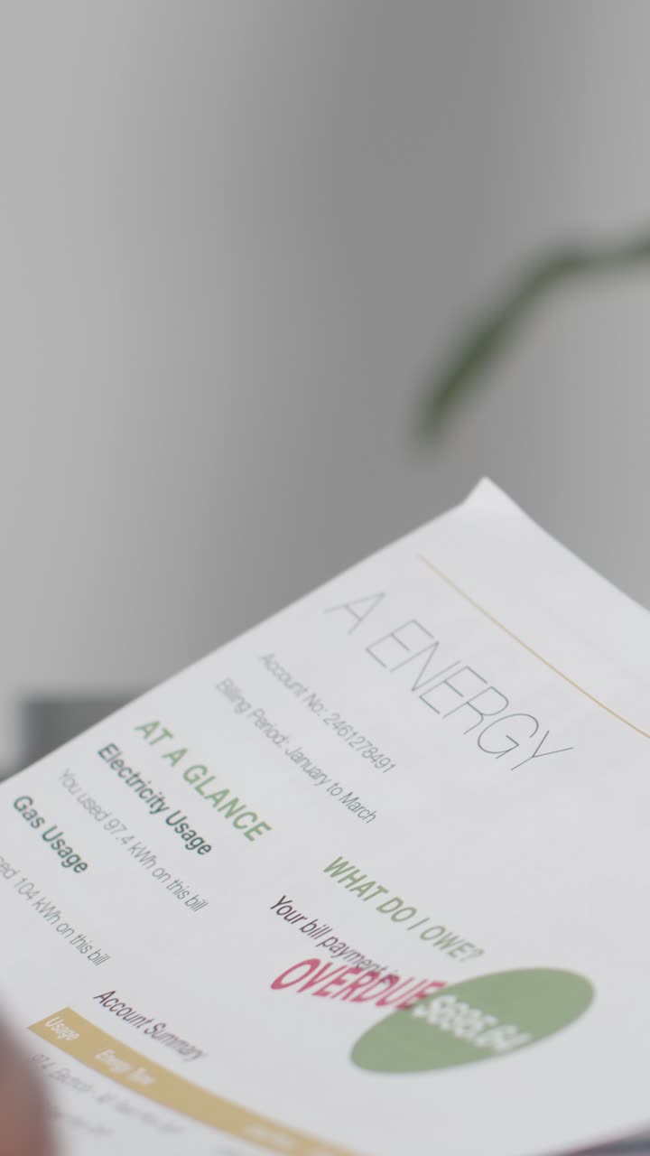 Close Up Vertical Video Of Person Looking At Overdue US Energy Bills