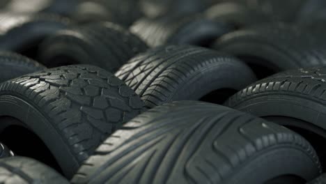 car tires in elegant studio lighting. the film is looped, arranged in an interesting way in a warehouse or store, the background of the car industry.