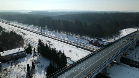 light traffic on the flyover bridge during winter sunny day with woods in the background in rakowice, poland
