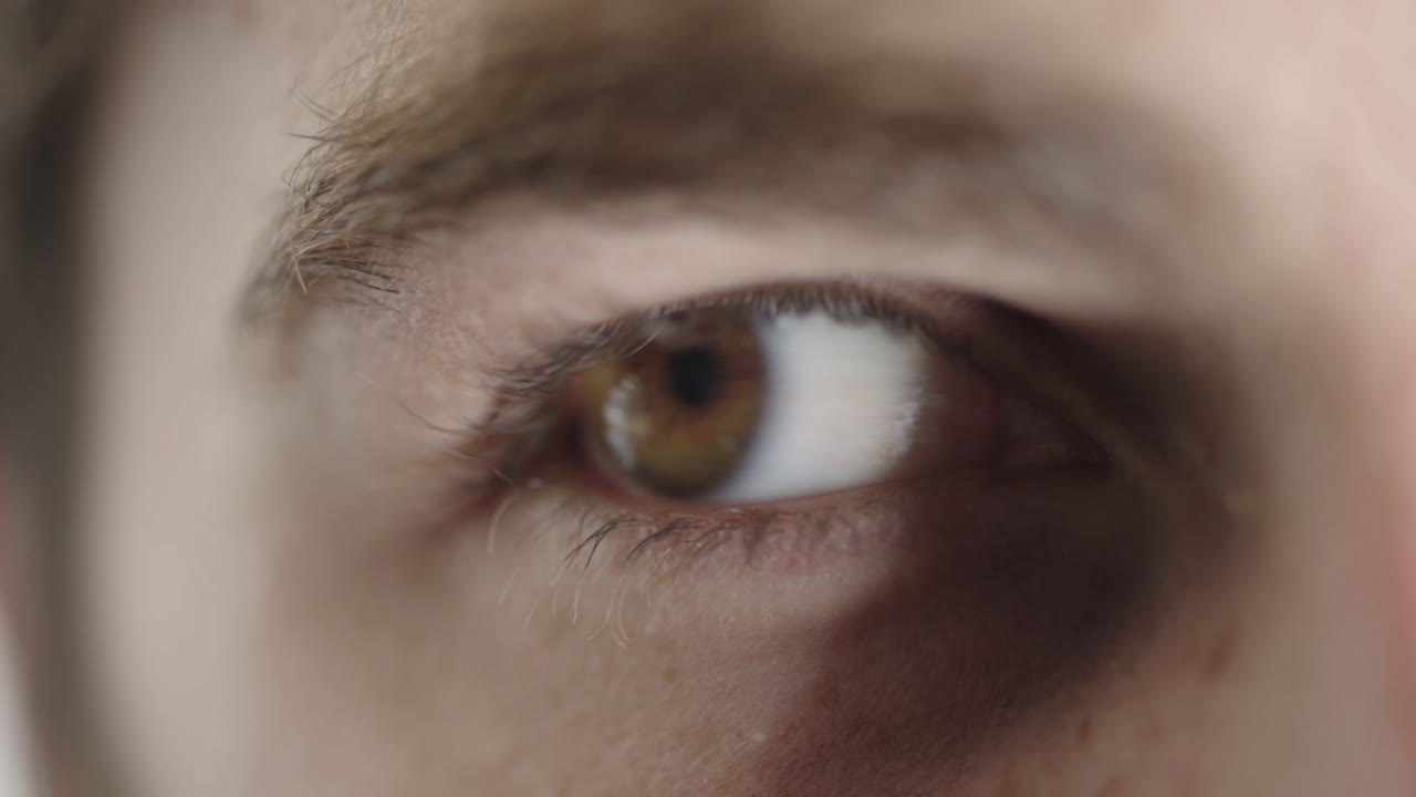 ojo masculino de cerca mirando a su alrededor parpadeando expresión óptica contemplativa pensativa