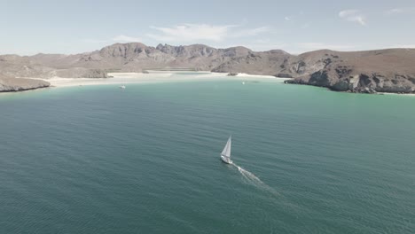 Boat-Sailing-In-The-Sea-Of-Cortez-With-Mountain-In-The-Background-In-Baja-California,-Mexico