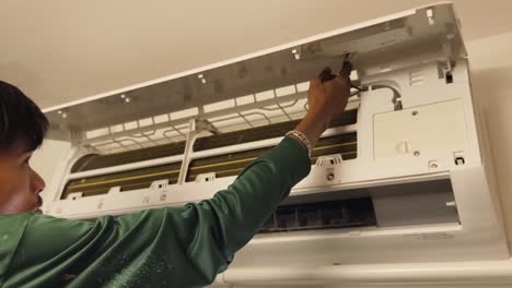 air conditioner repair or maintenance by technician