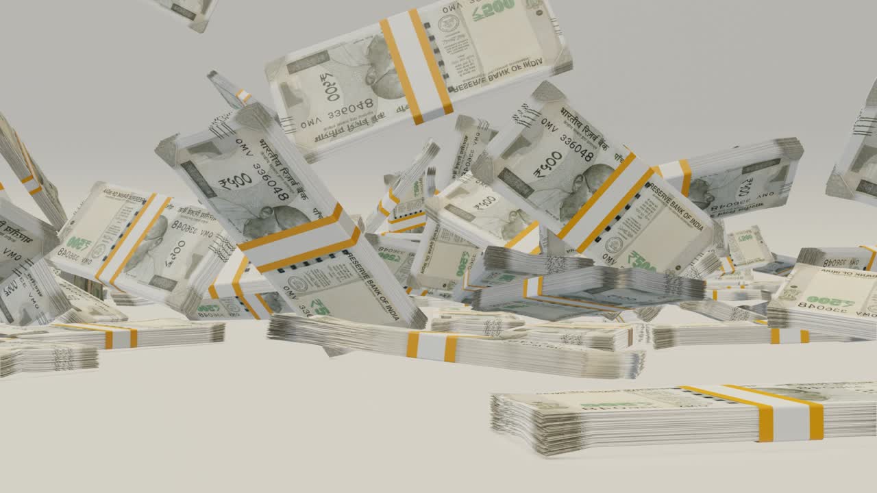 Many wads of money falling on table. Indian Rupees banknotes.