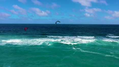 two kite surfers in the atlantic ocean on a beautiful day