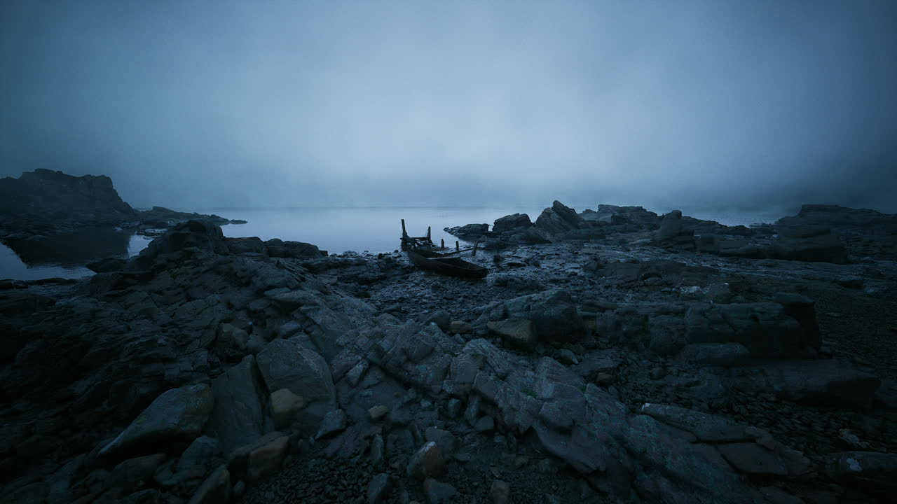 Foggy shoreline with rocky landscape and a lone boat on the water