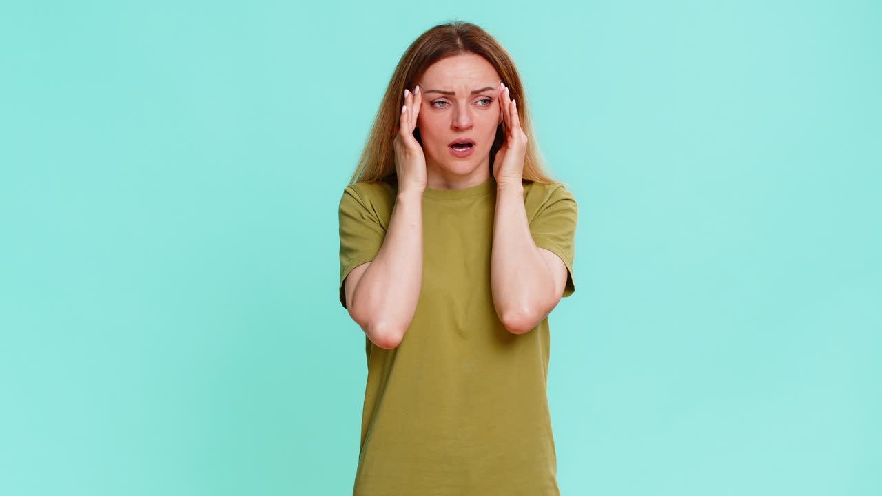 Woman holding head massaging temples in pain suffering from migraine intense sharp headache attack