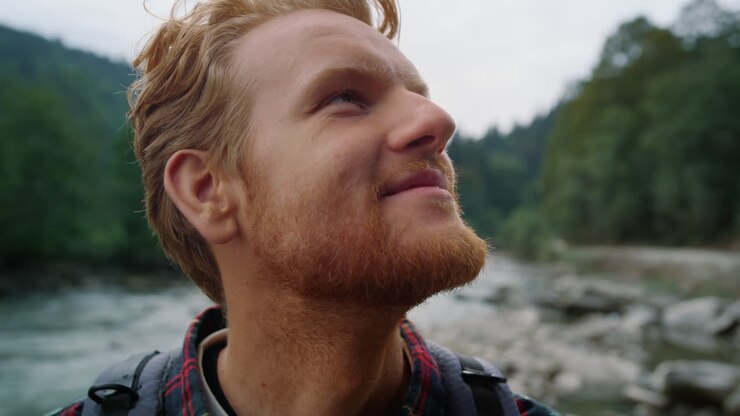Man looking around mountain landscape. Hiker enjoying picturesque place