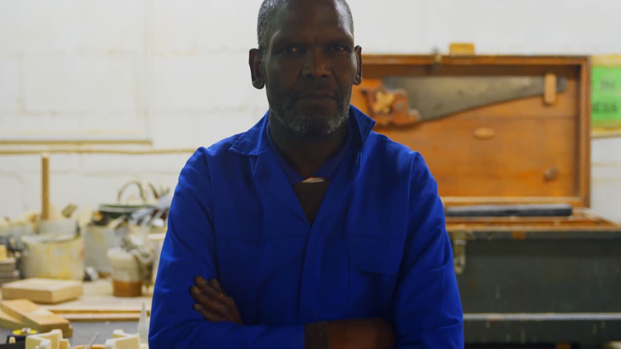 Worker standing with arms crossed in foundry workshop 4k