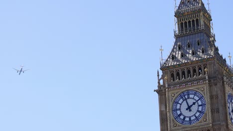 airplane flying past big ben clock tower