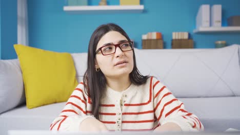 Creative-young-woman-with-braces-is-thinking-about-idea-at-home.