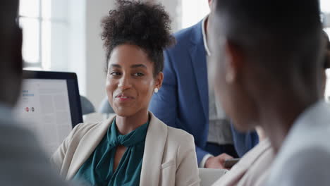 mixed race business woman chatting with colleagues in office meeting having conversation sharing ideas in corporate workplace