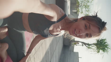 sporty woman filming her on roof