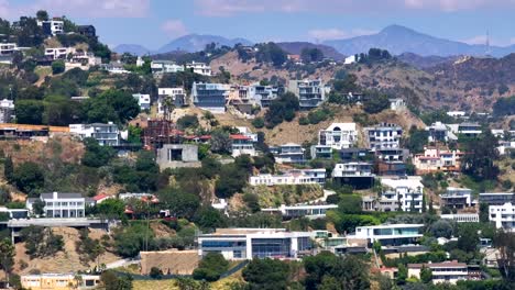 aerial view cutting across large luxury neighborhood of homes in hollywood hills daytime landscape