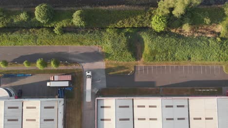 truck reversing at the warehouse in park west business park in dublin, ireland for loading of stocks - aerial shot