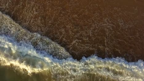 Toma-Aérea-De-Un-Dron-Mirando-Directamente-Hacia-Las-Olas-Que-Suben-Por-La-Playa-En-Coffs-Harbour