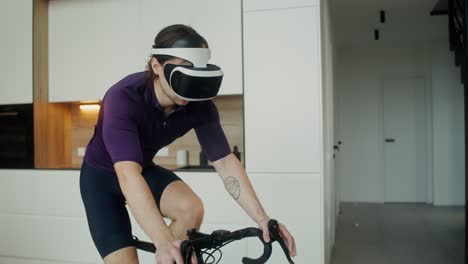 man wearing vr headset cycling at home