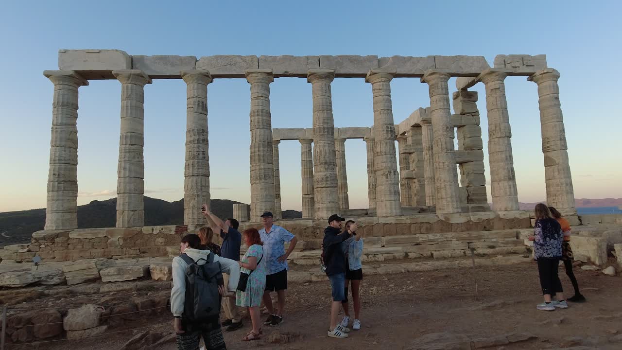 Tourists taking pictures at Temple of Athena Sounias