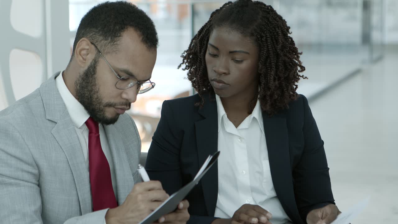 Young business people working with papers