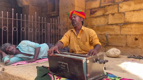 man with harmonium in the street of rajasthan