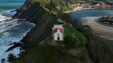 spectacular views of the hermitage of la guia dominating the entrance to the cove of the mythical port of ribadesella in asturias