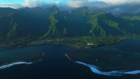 golden hour sunset towering mountain peaks surf reef break channel teahupoo wave tahiti french polynesia aerial drone view incredible island landscape clouds olympics moorea bora bora papeete forward