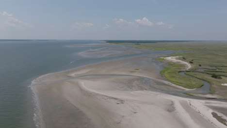 aerial video of hilton head island shows white sandy beaches meeting calm blue waters and sprawling green marshes