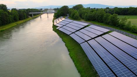 Captivating-aerial-4K-drone-footage-of-a-solar-panel-plant-nestled-alongside-the-Drava-river-in-Slovenia