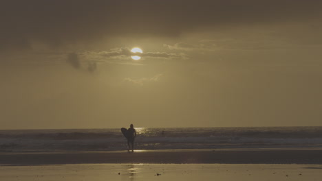surfer at sunset beach