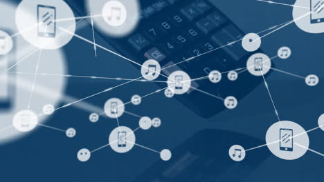 Animation-of-network-of-music-and-media-icons-over-calculator-falling-on-desk