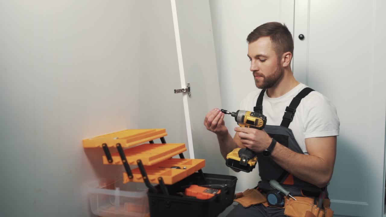 primer plano, un joven instala cortinas en la puerta de un armario