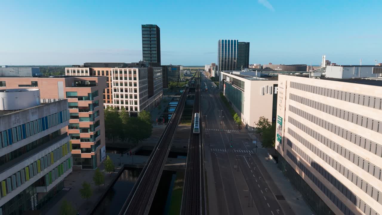 Flying above main Orestad metro railway line through residential area, Denmark