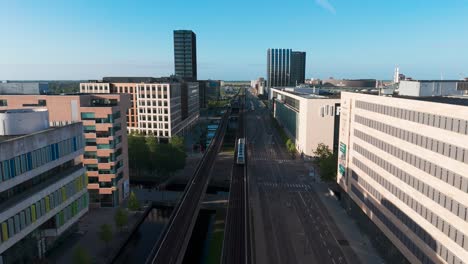 flying above main orestad metro railway line through residential area, denmark