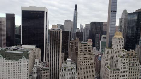 aerial view of skyscrapers, in midtown manhattan, overcast day, in new york city, usa - tracking, drone shot