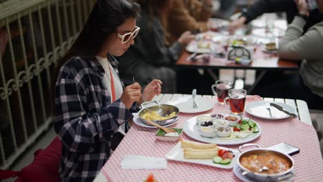 woman enjoying a turkish breakfast outdoors