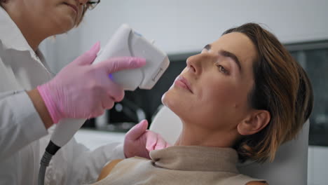 woman receiving ultrasonic therapy in beauty salon closeup. ultrasound treatment