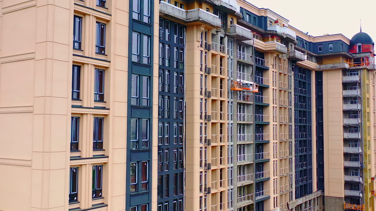 Residential apartment buildings under construction. Building of a modern multi storey apartment house. Real estate development.