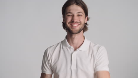 caucasian man in front of camera on gray background.