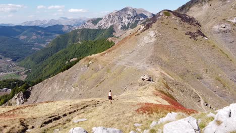 Mujer-Camina-Cuesta-Abajo-Por-Un-Sendero-De-Montaña-En-El-Parque-Nacional-De-Prokletije,-Montenegro---Dolly-Sigue