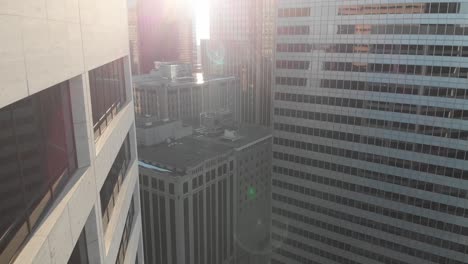 aerial footage of downtown minneapolis, crossing by buildings, sunny afternoon